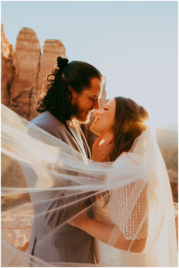 bride and groom leans in for a kiss during sunset at Cathedral Rock