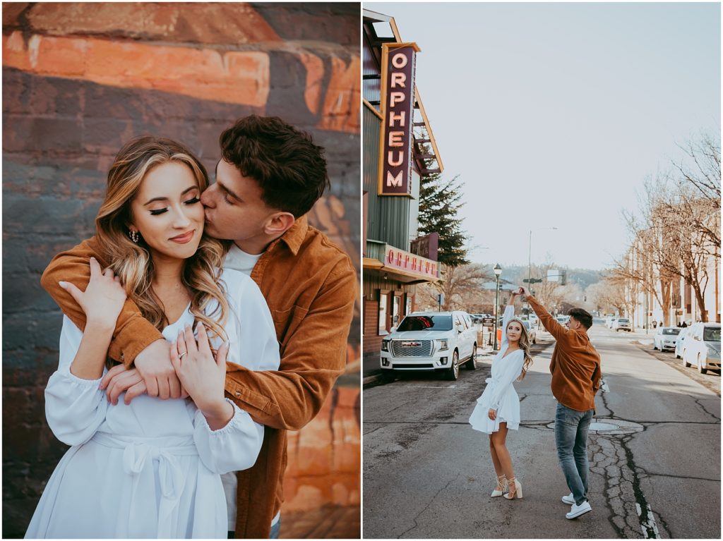 Boy kisses girls cheek while wrapping his arms around her near Orpheum Theatre in Flagstaff engagement photos