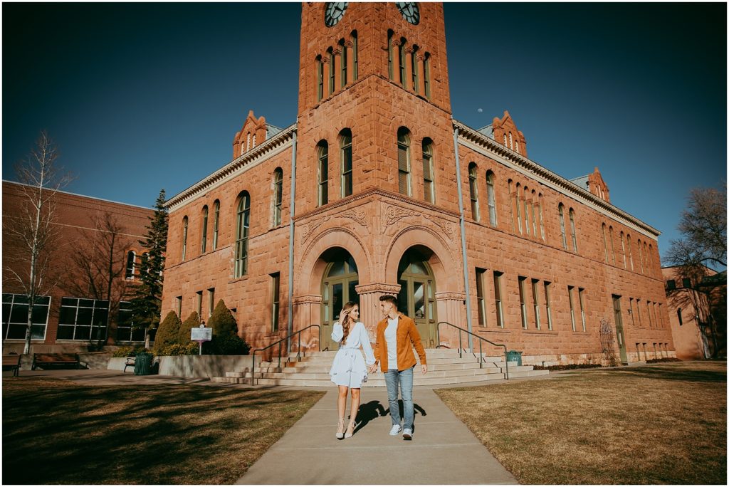 Couple walks away from the courthouse in downtown Flagstaff for engagement photos