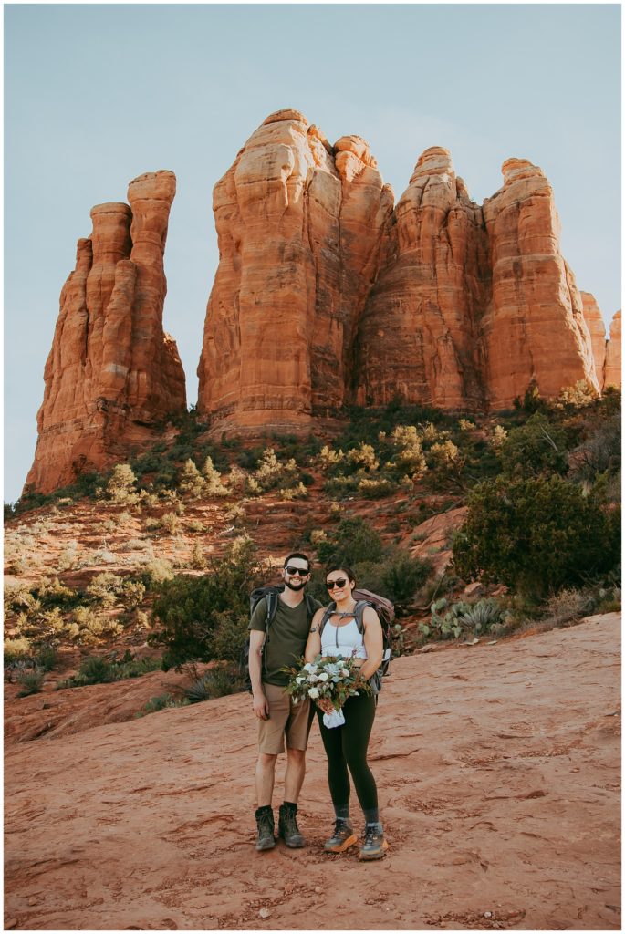 couple hiking before their bridal photos at Cathedral Rock in Sedona