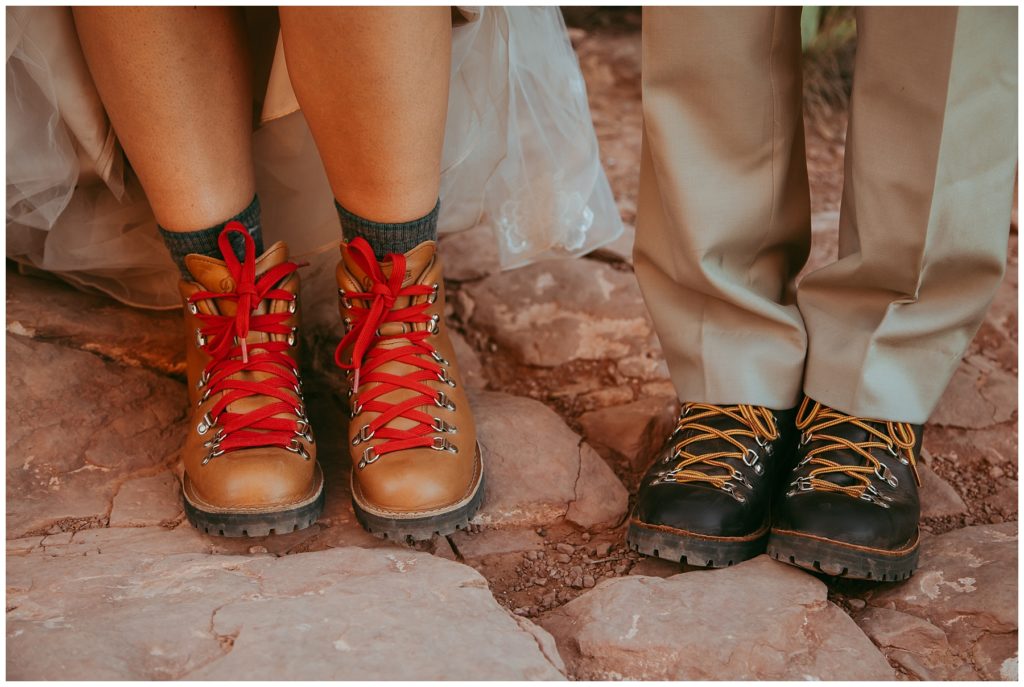 bride and groom stand in hiking boots on Cathedral Rock