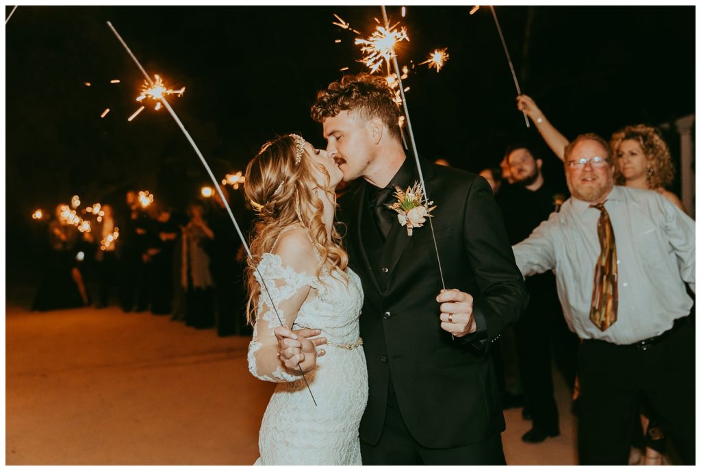 bride and groom with sparklers at reception