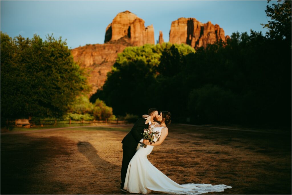 Bride and groom kisses during elopement at Crescent Moon Ranch during low cost Sedona elopement