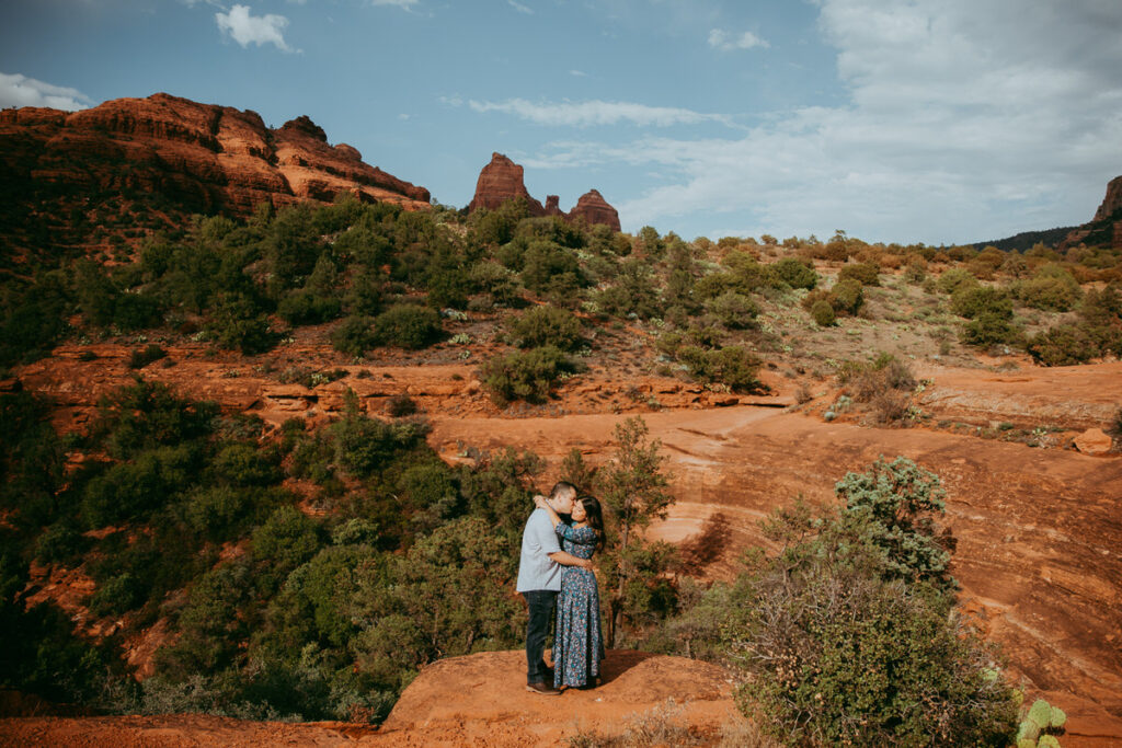 A couple kisses while embracing at Sedona's Munds Wagon Trail.