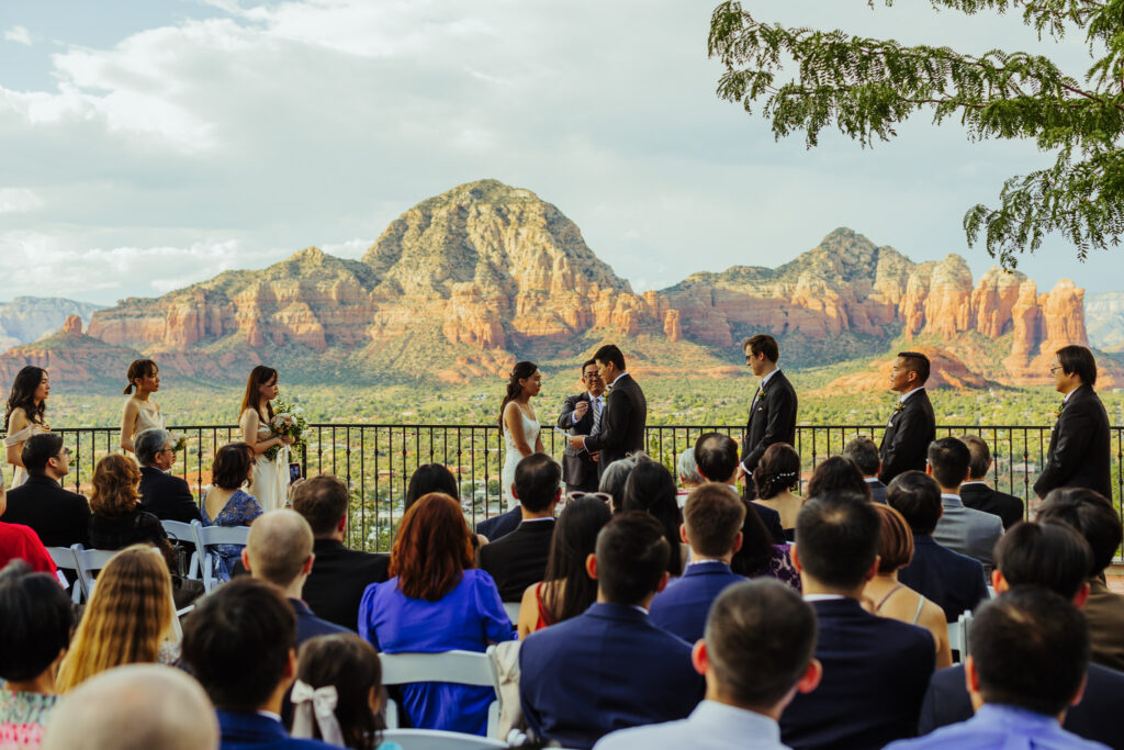 bride and groom read vows as sky ranch lodge in sedona in front of red rocks