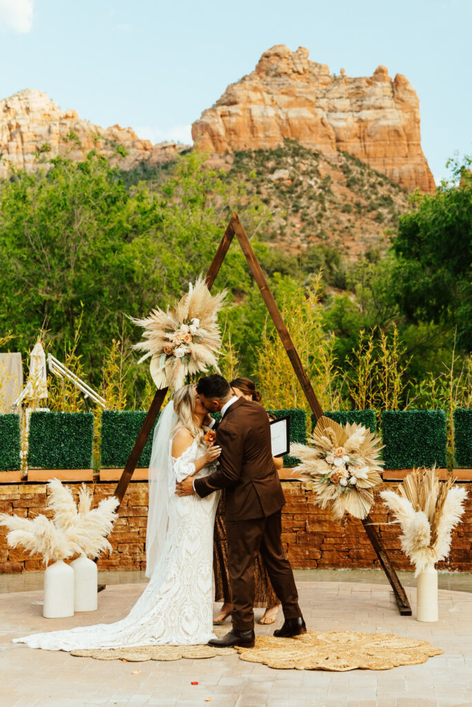 groom kisses bride at amara resort wedding ceremony location in sedona arizona