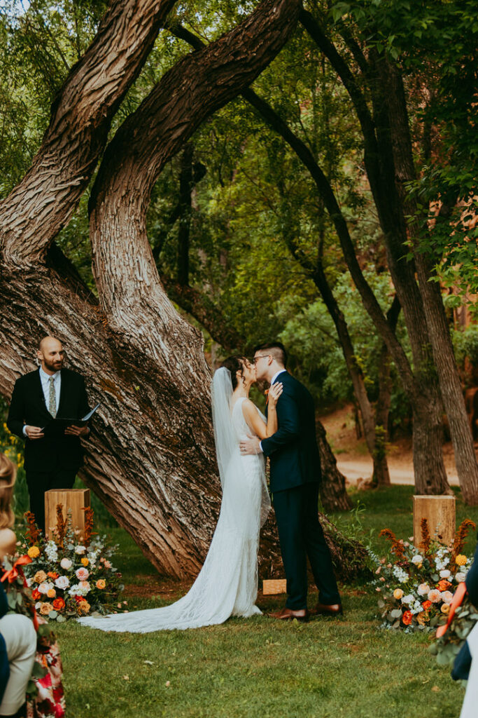bride and groom sharing their first kiss