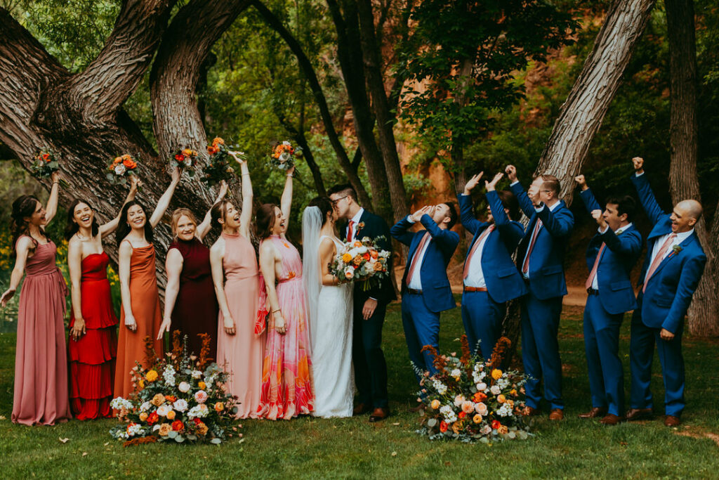bridal party cheering on wedding couple for photos