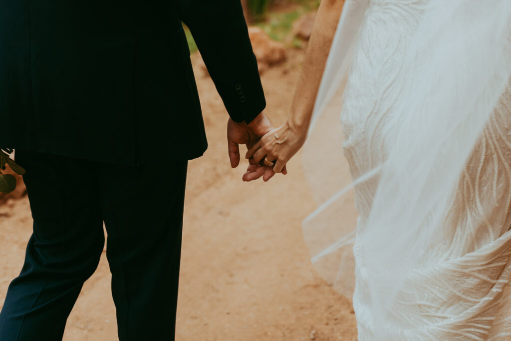 bride and groom holding hands together
