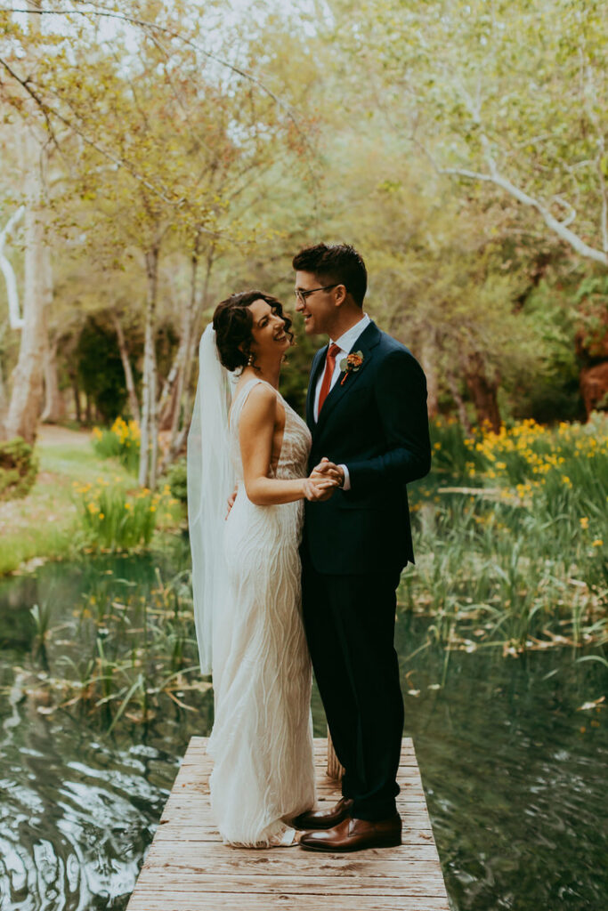Kristi and Paul share a quiet moment by the private lake at Los Lagos Estate, one of Sedona’s hidden gem wedding venues.