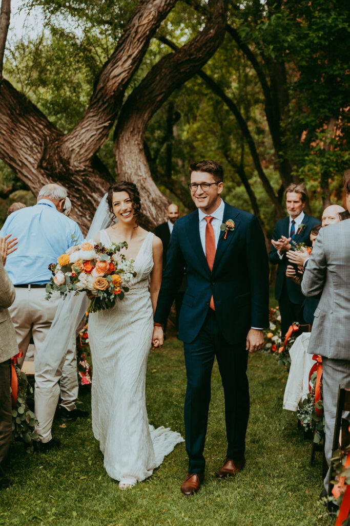bride and groom walking down the isle