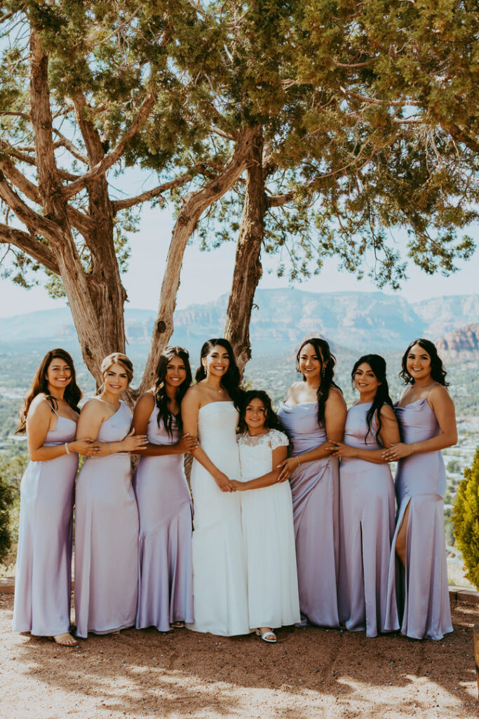 bridesmaids standing with pastel colored dresses in sedona arizona