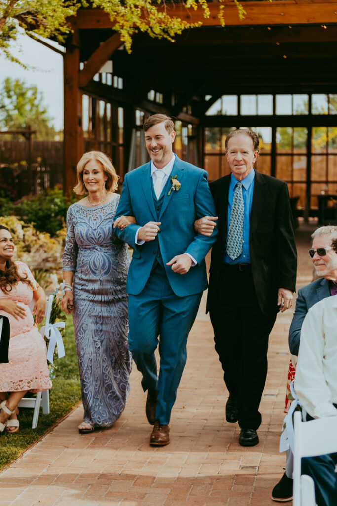 groom walking down the aisle at a wedding at sky ranch lodge