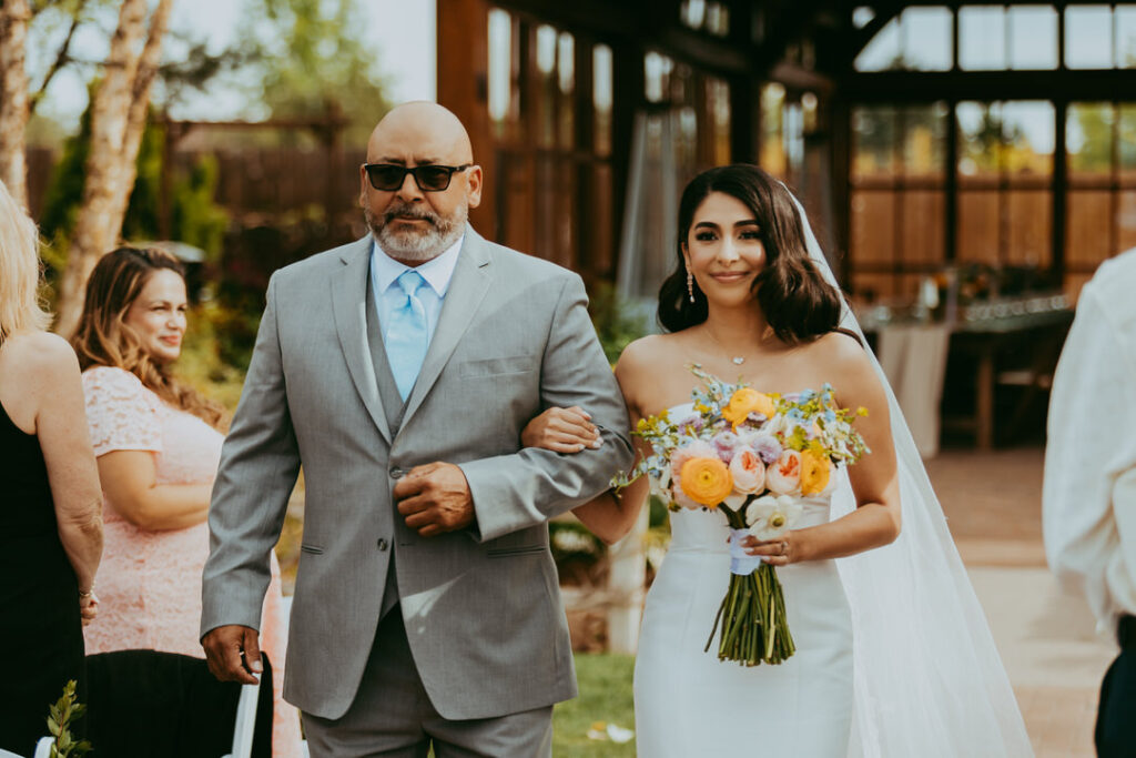 bride seeing her groom while holding onto dad