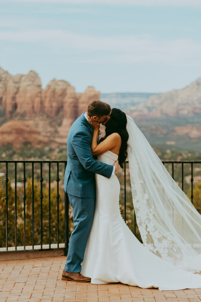bride and groom sharing their first kiss at sky ranch lodge in sedona arizona