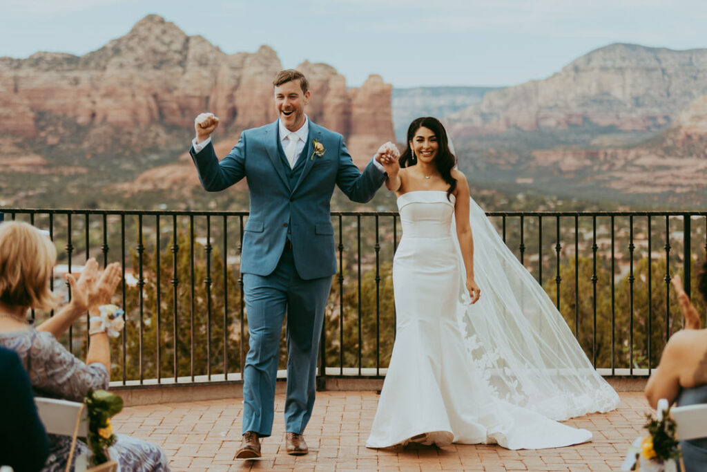 sedona wedding photo of bride and groom walking down aisle at sky ranch lodge