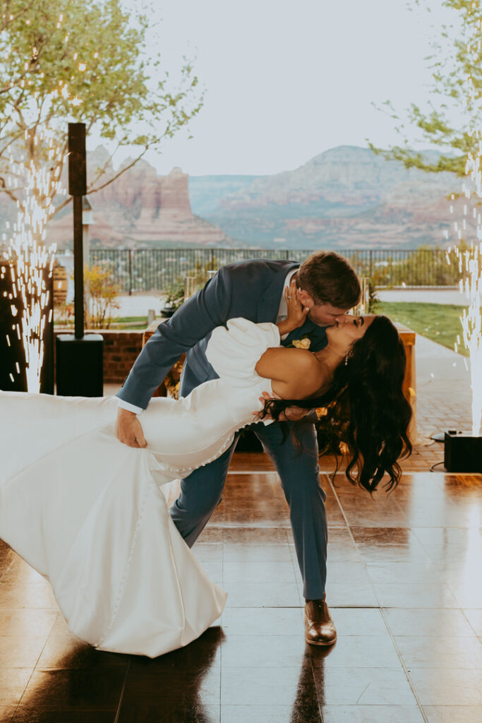 bride and groom kiss as sparks fly for their first dance in Sedona