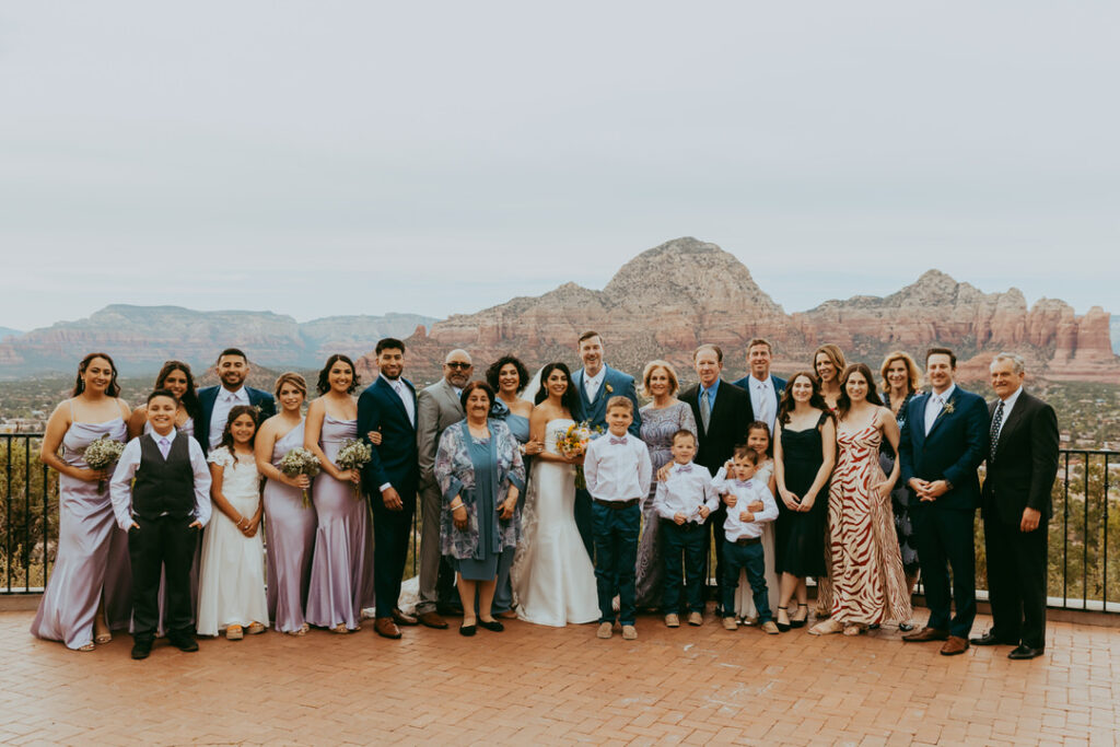 large group photo at sky ranch lodge with thunder mountain behind them