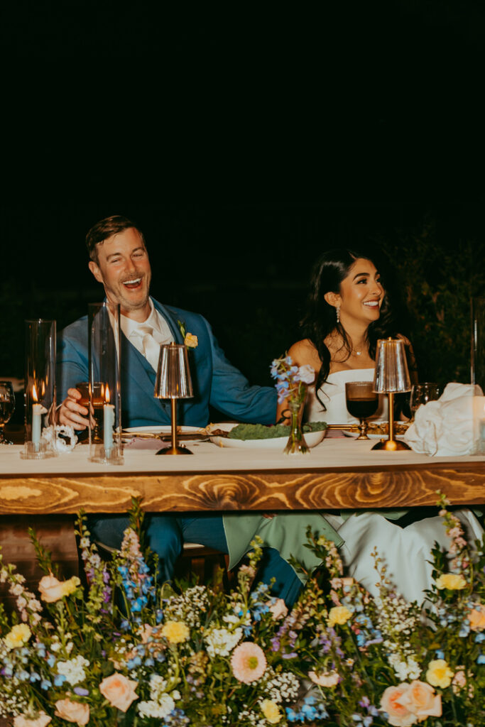 bride and groom laughing during speeches