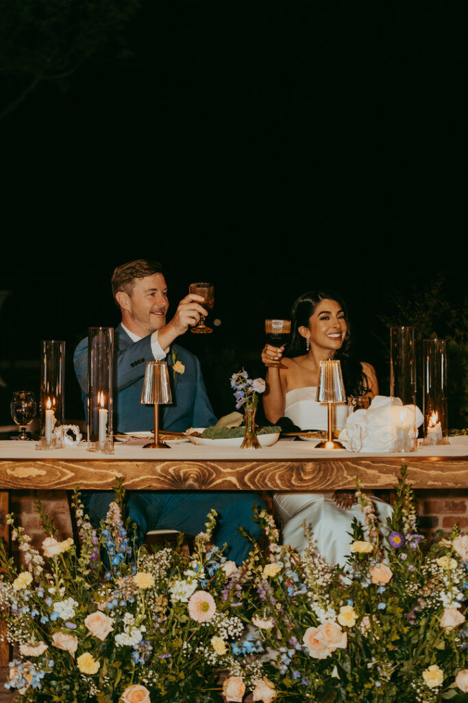 bride and groom cheer after wedding speeches