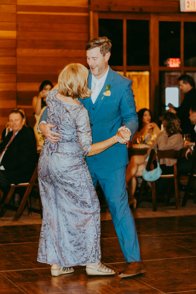 groom and mother dancing at reception