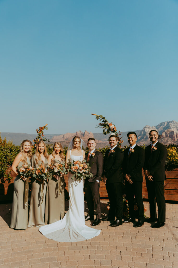 Wedding party stands with red rock views taken by sedona wedding photographer at agave of sedona.