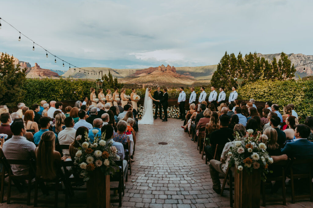 Agave of Sedona wedding photographer captures the ceremony of a couple with the red rocks surrounding them. 