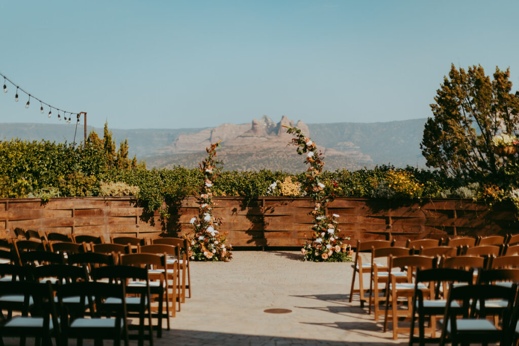  Intricate ceremony and floral arrangements against the red rock backdrop.