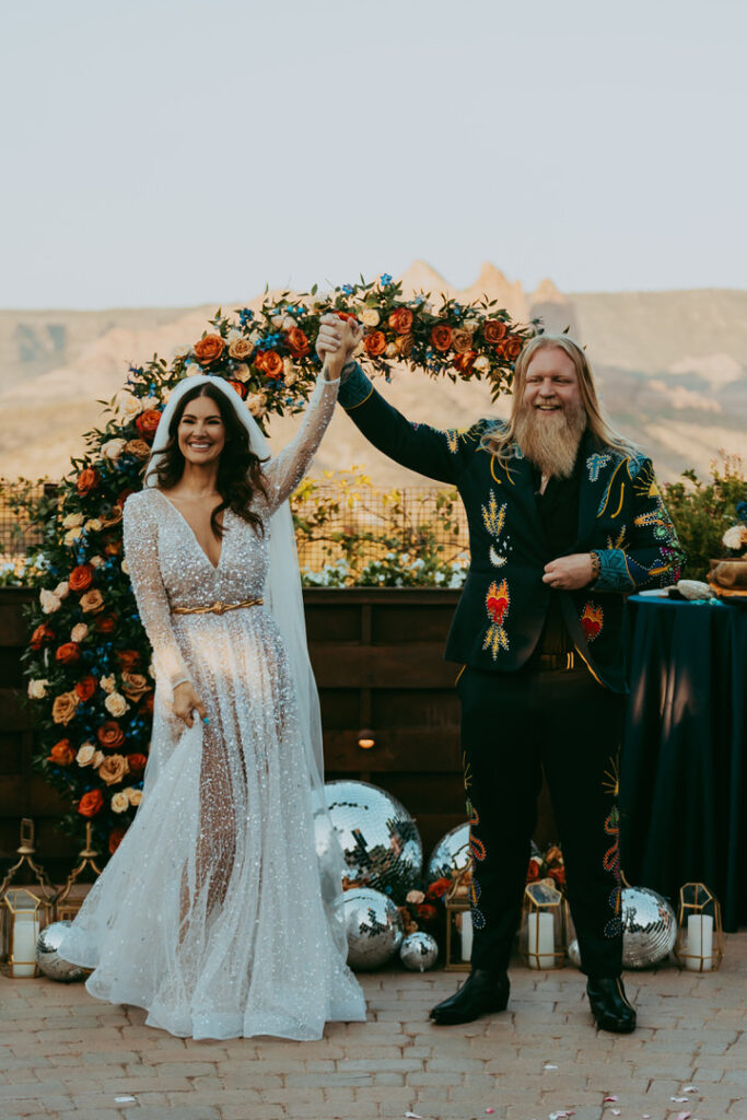 Couple cheers as they celebrate their wedding in Sedona Arizona. 